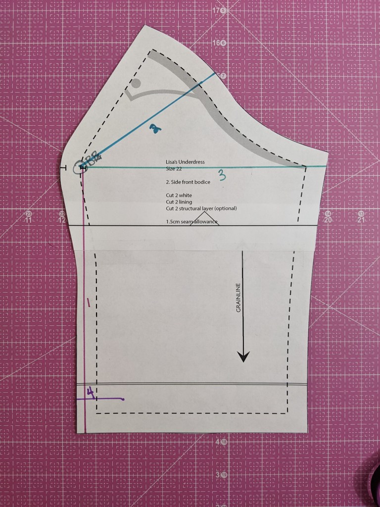 Overhead shot of side front bodice piece. Colored lines are drawn to indicate alterations. 