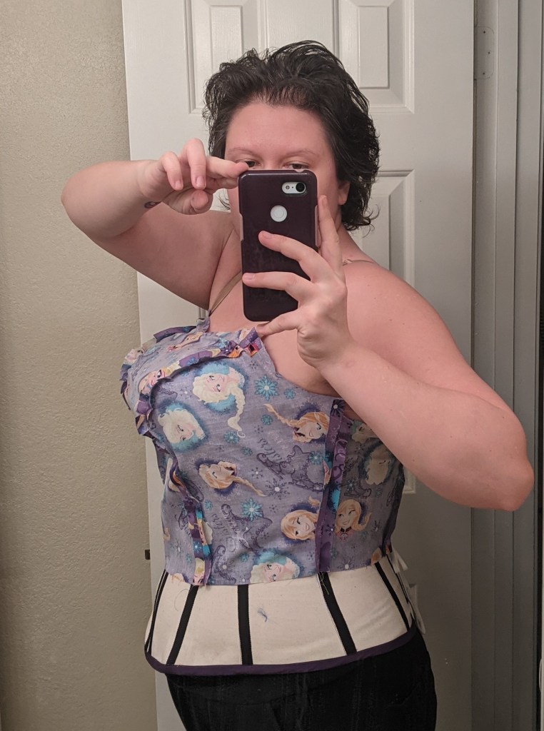 Mirror selfie of TGS checking the side fit of her mockup.